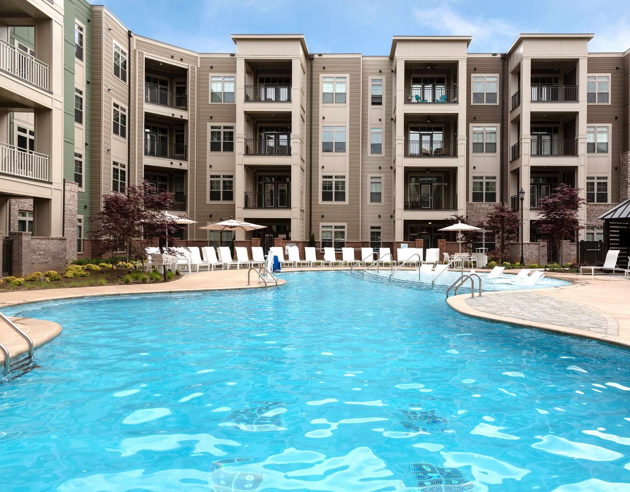 Luxury pool with blue water outside of Providence Row Apartments