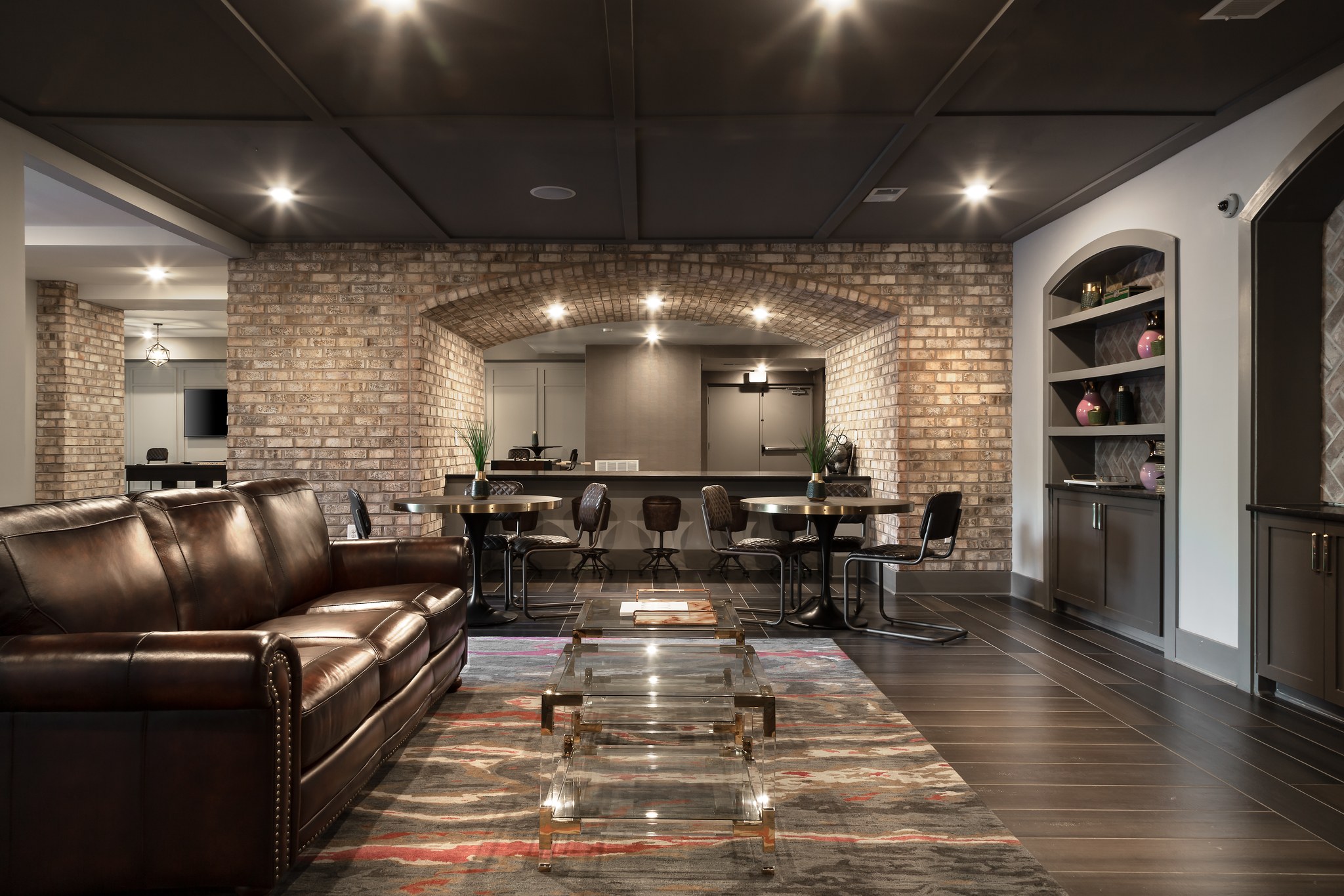 Wine room with leather couch, tables, and beautiful bar area