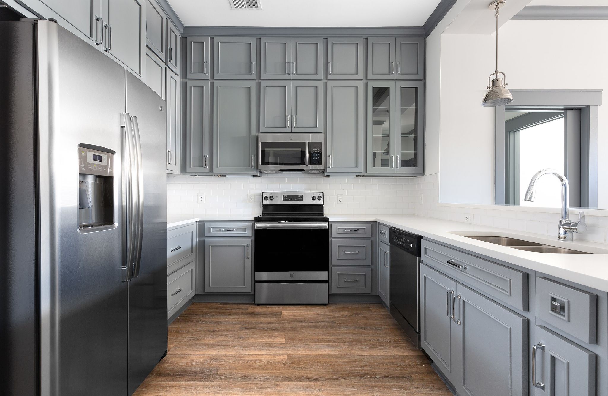 close up of kitchen with energy star appliances, gray cabinets, and beautiful countertops at Providence Row Apartments in SouthPark